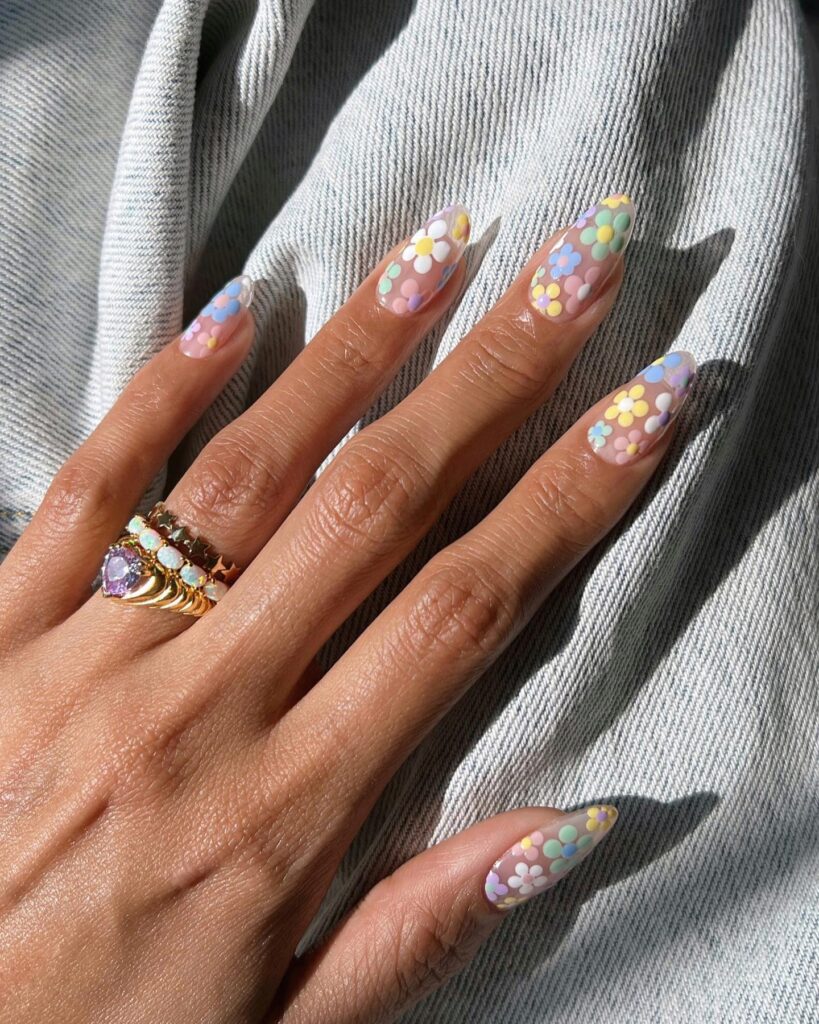 long almond nails covered in colorful retro pastel daisies