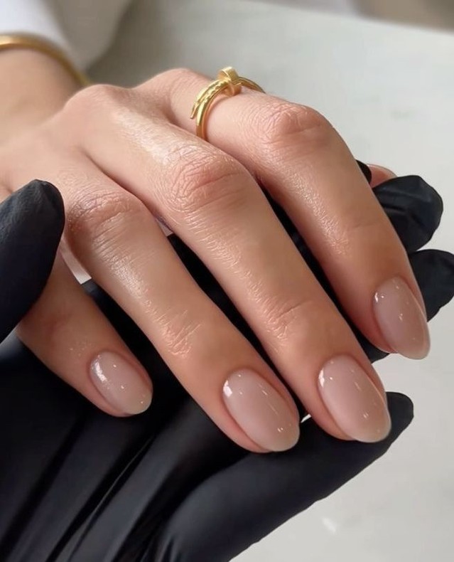 Short round nails with warm beige nude glossy polish