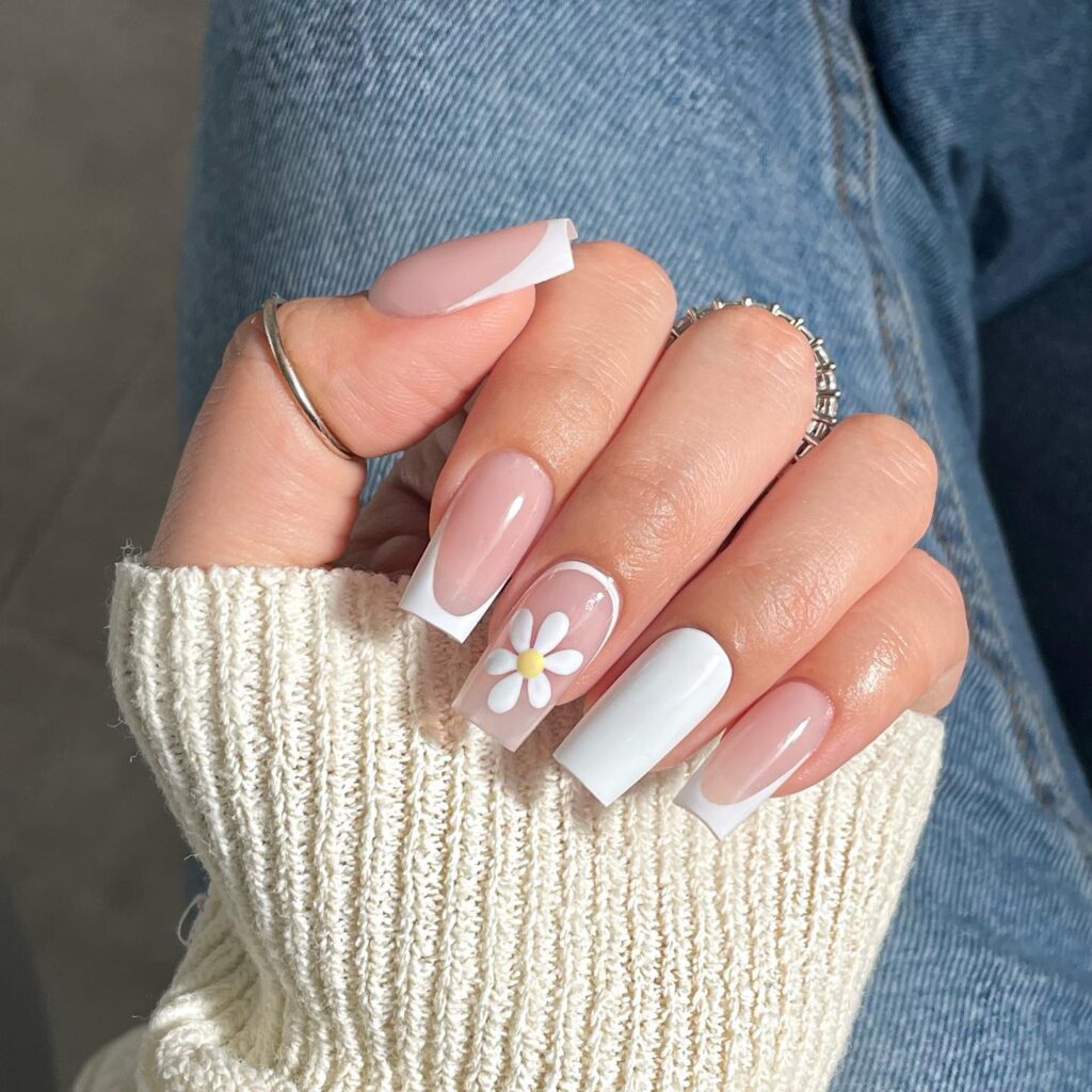 square coffin nails with white french tips and oversized daisy on one accent nail