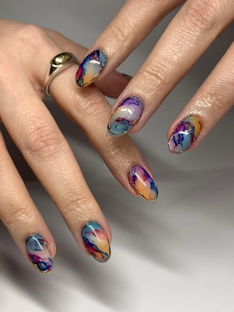 abstract watercolor nail design in pastels