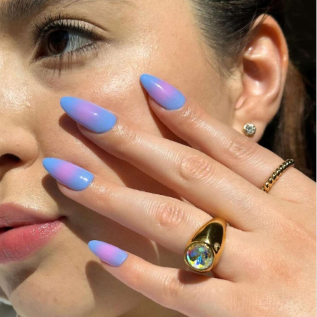 Periwinkle and pink aura nails in an almond shape