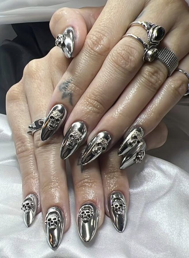 nails with silver chrome polish and 3D skull accents