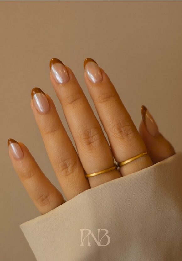 Nude nails with glossy brown French tips