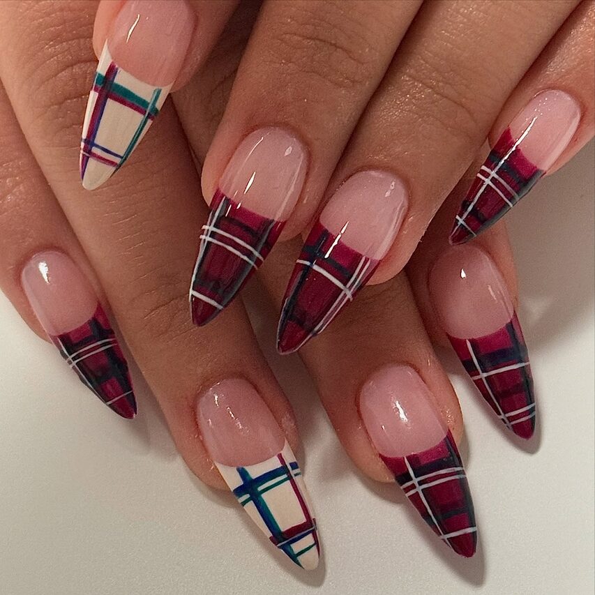 Stiletto nails with burgundy plaid French tips and accent plaid designs