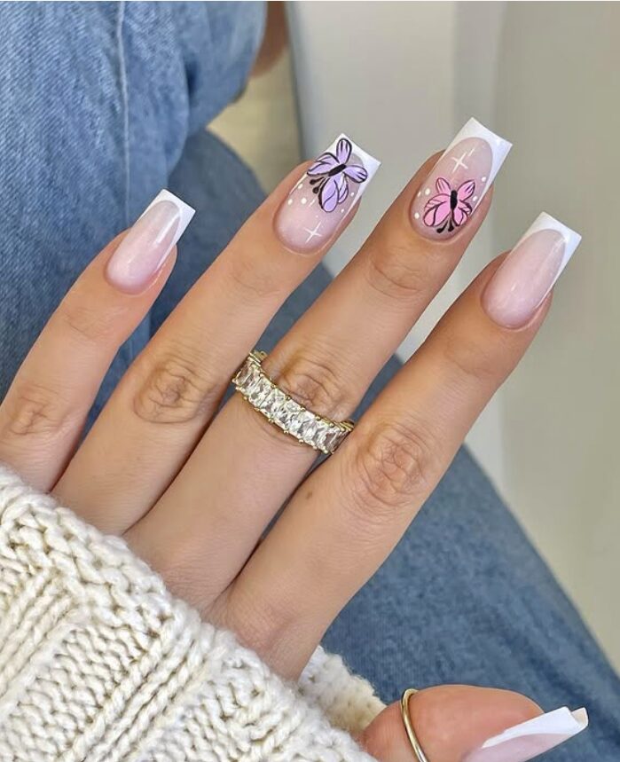 Square French tip nails with pink and purple butterfly accents on two fingers