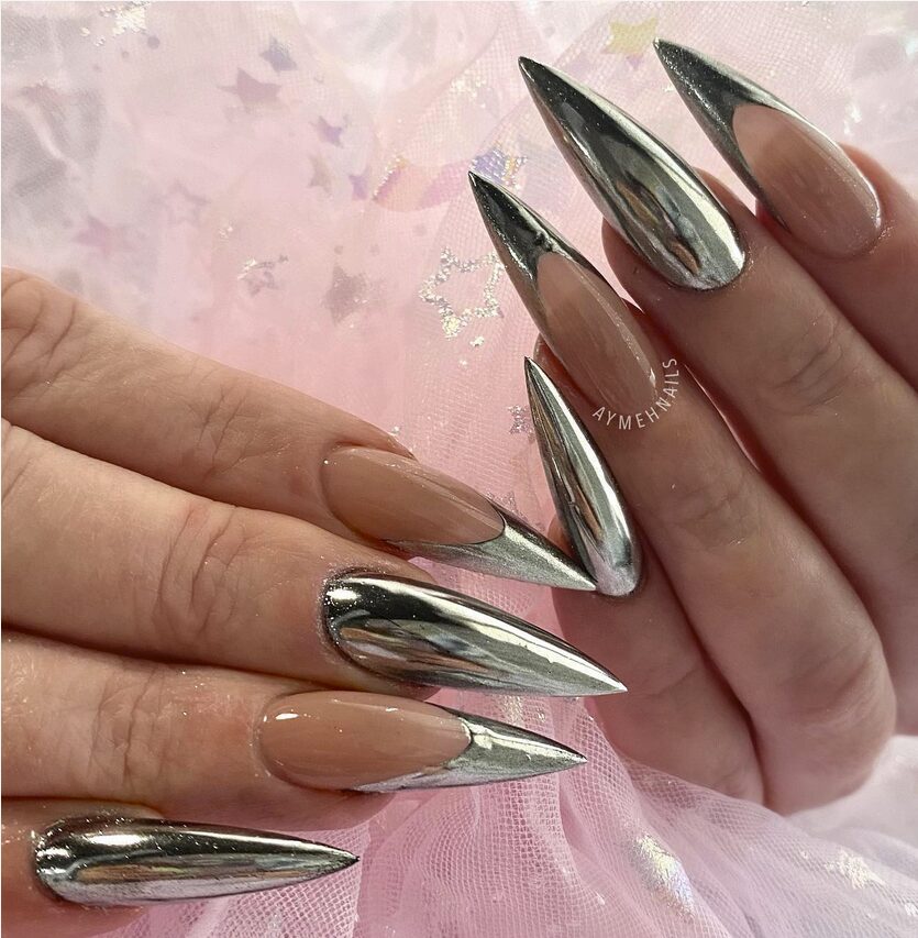 hands featuring pointed Chrome Stiletto Nails