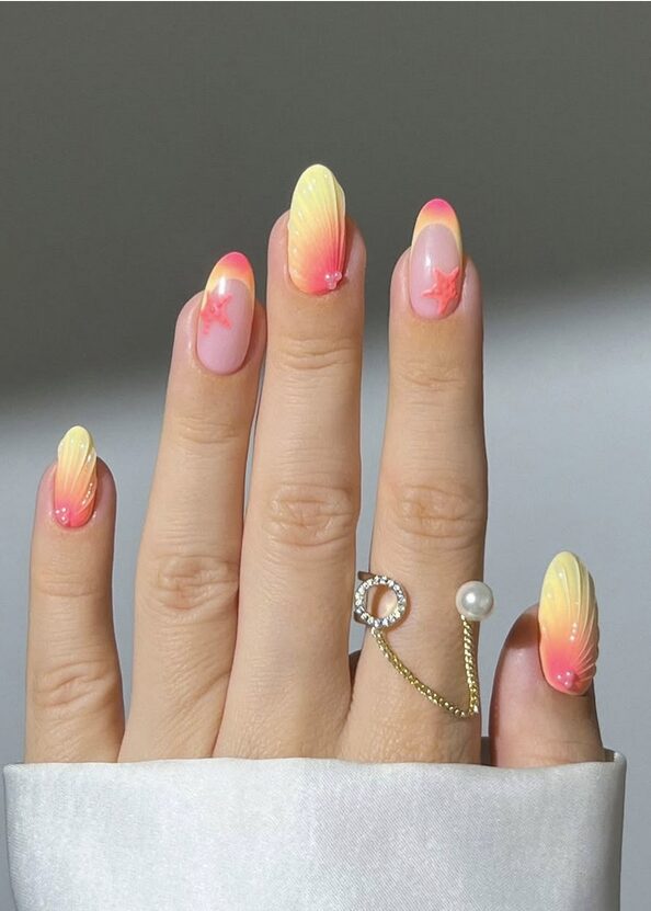 Coral ombre nails with yellow and pink gradient tones