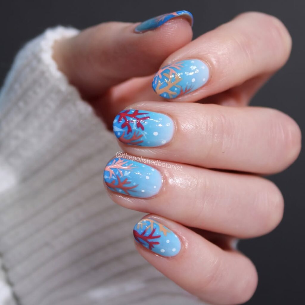 vibrant coral orange nail art with blue base