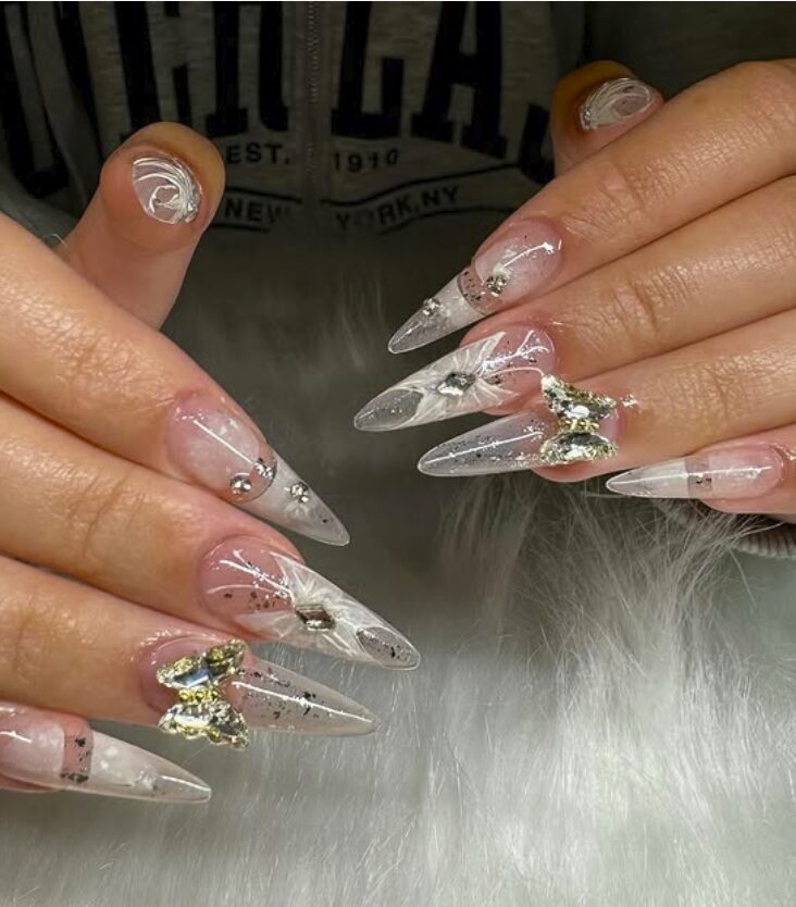 Clear stiletto nails with crystal butterflies and silver accents