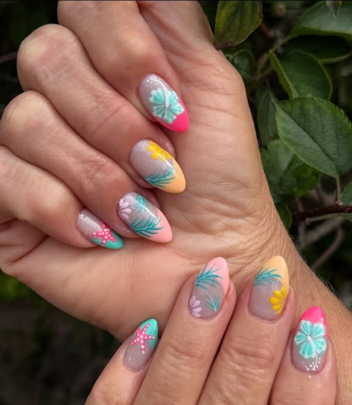 Colorful tropical nails with flowers, palm leaves, and bright tip accents
