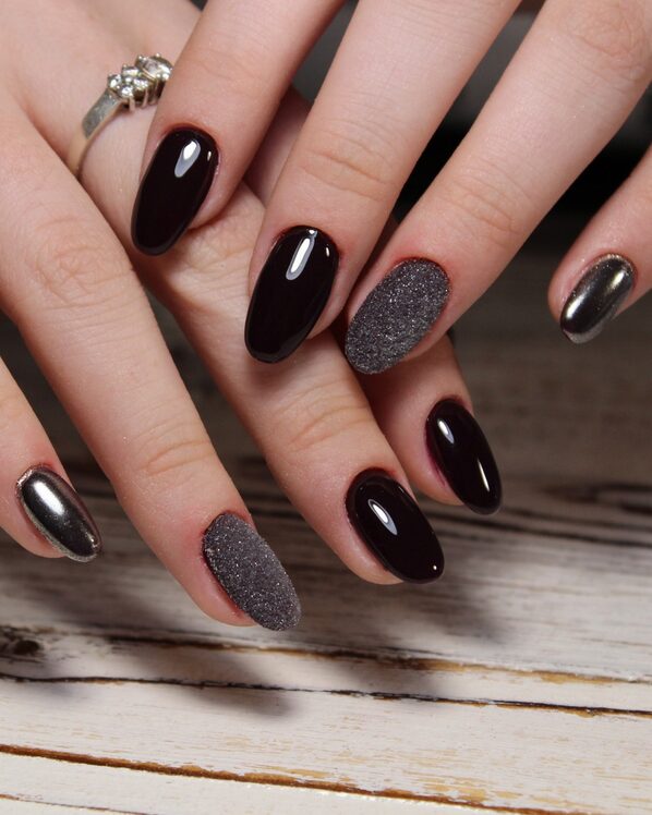nails with a dark ombré base fading into a sleek chrome finish