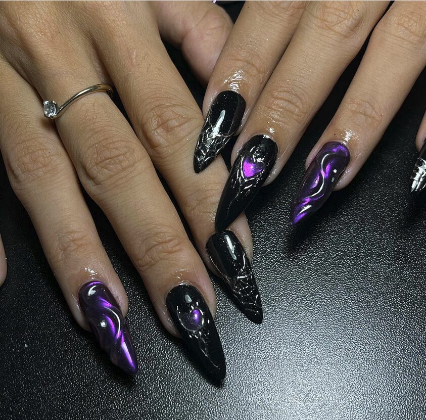 long stiletto nails featuring black and purple chrome finishes with sculpted 3D textures and metallic details