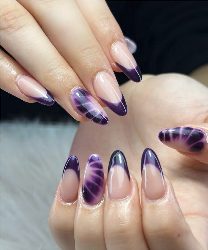 Nude almond nails with dark purple gradient tips and smoky designs