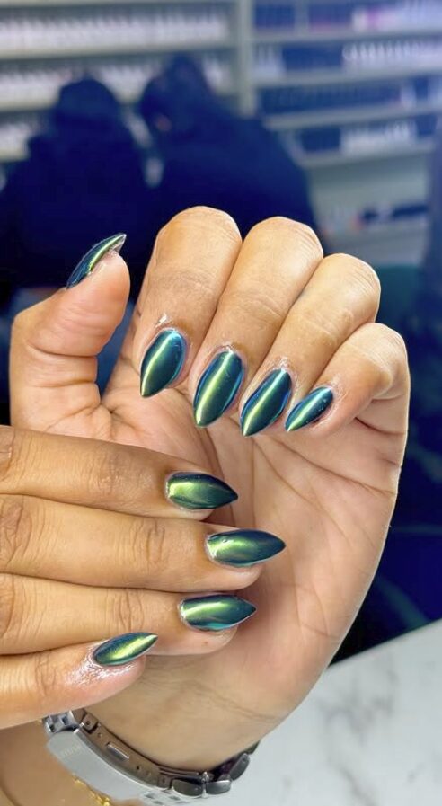 nails with a deep emerald green chrome finish