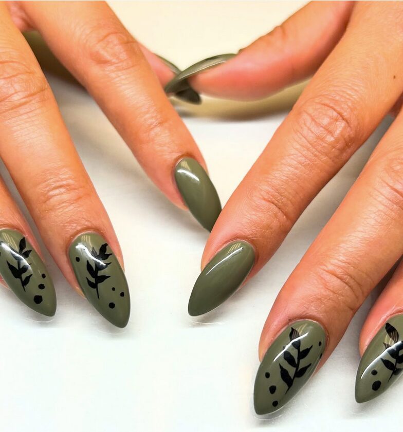 Olive green almond nails with simple black leaf accents