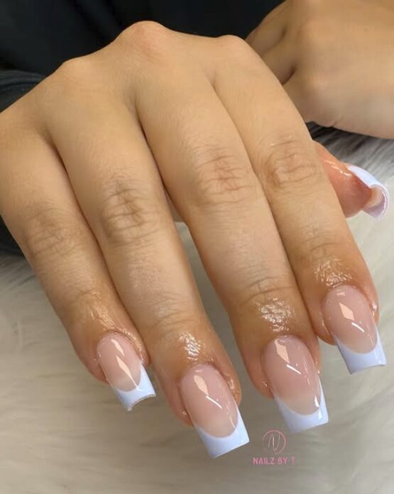 Glossy nude nails with pastel periwinkle French tips