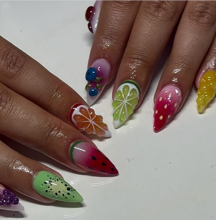 long stiletto nails decorated with bold 3D fruit designs