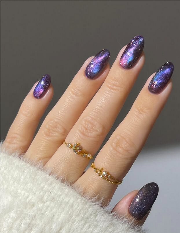 Galaxy-inspired purple nails with pink and blue shimmer