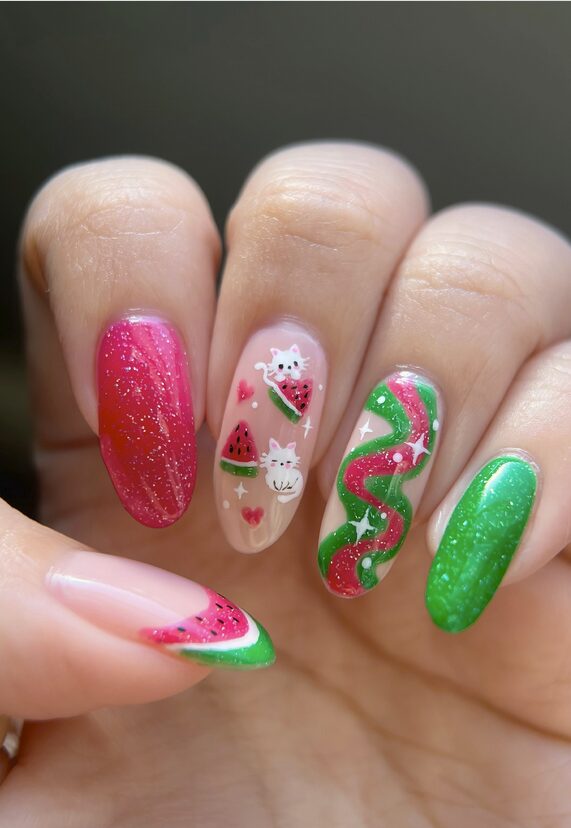 Watermelon-themed nails with glitter, cats, hearts, and wavy green-pink designs