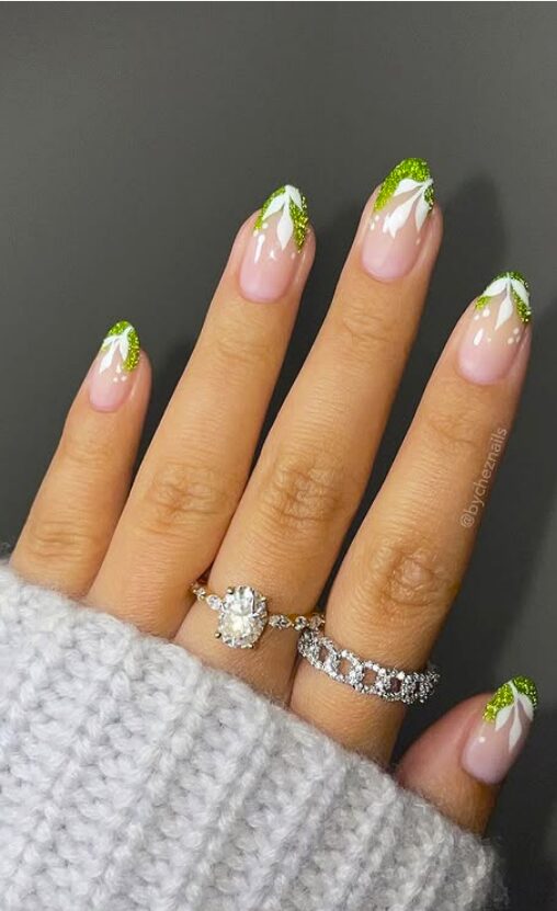 Pink glossy nails with green glitter leaf tips