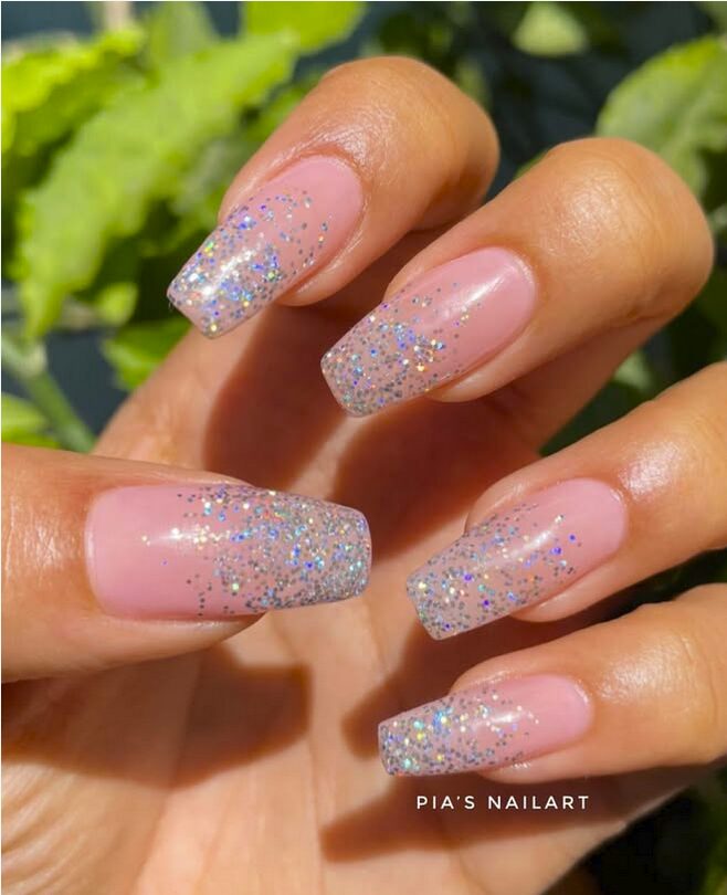 Glitter ombre nails with a pink nude base and silver sparkly tips