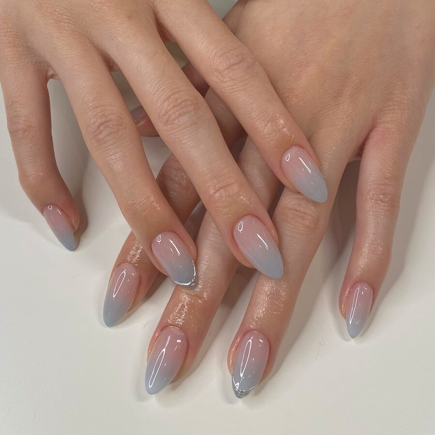 Soft grey ombre nails with a sheer nude base fading into cool-toned grey tips