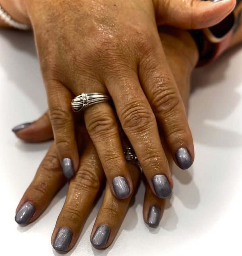 nails painted with a smooth gunmetal gray metallic polish
