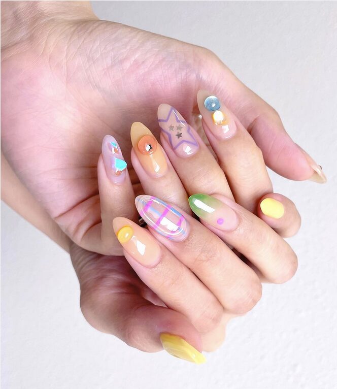 Colorful jelly-style nails with playful dots, stars, and glossy translucent designs