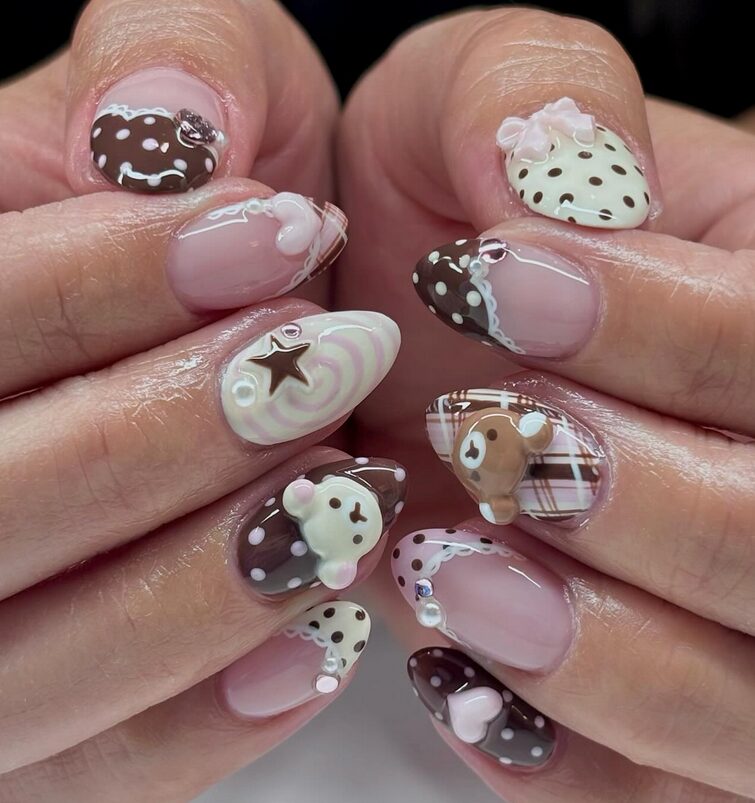 Close-up of brown and pink nails with 3D bear charms and chocolate-themed designs
