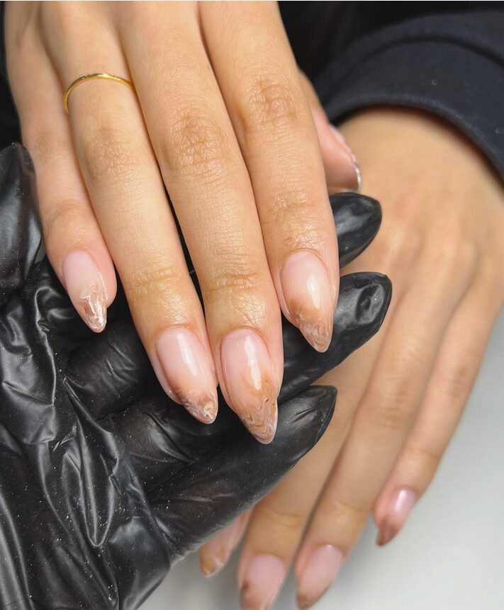 Nude nails with soft brown latte-swirl tips
