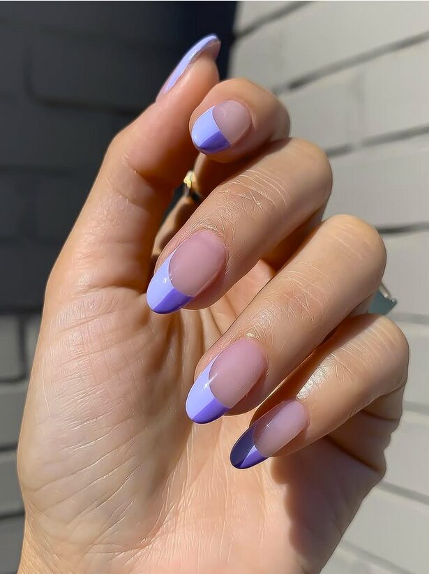 Two-tone lilac French tip nails on a nude base
