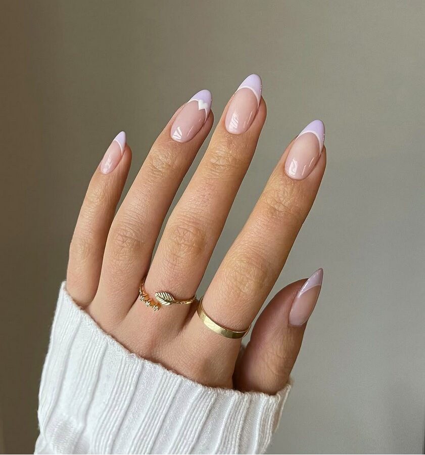 Lilac French tip almond nails with a soft nude base