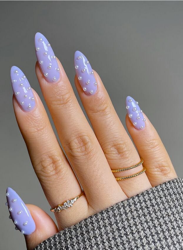 Lilac almond nails decorated with small pearl accents