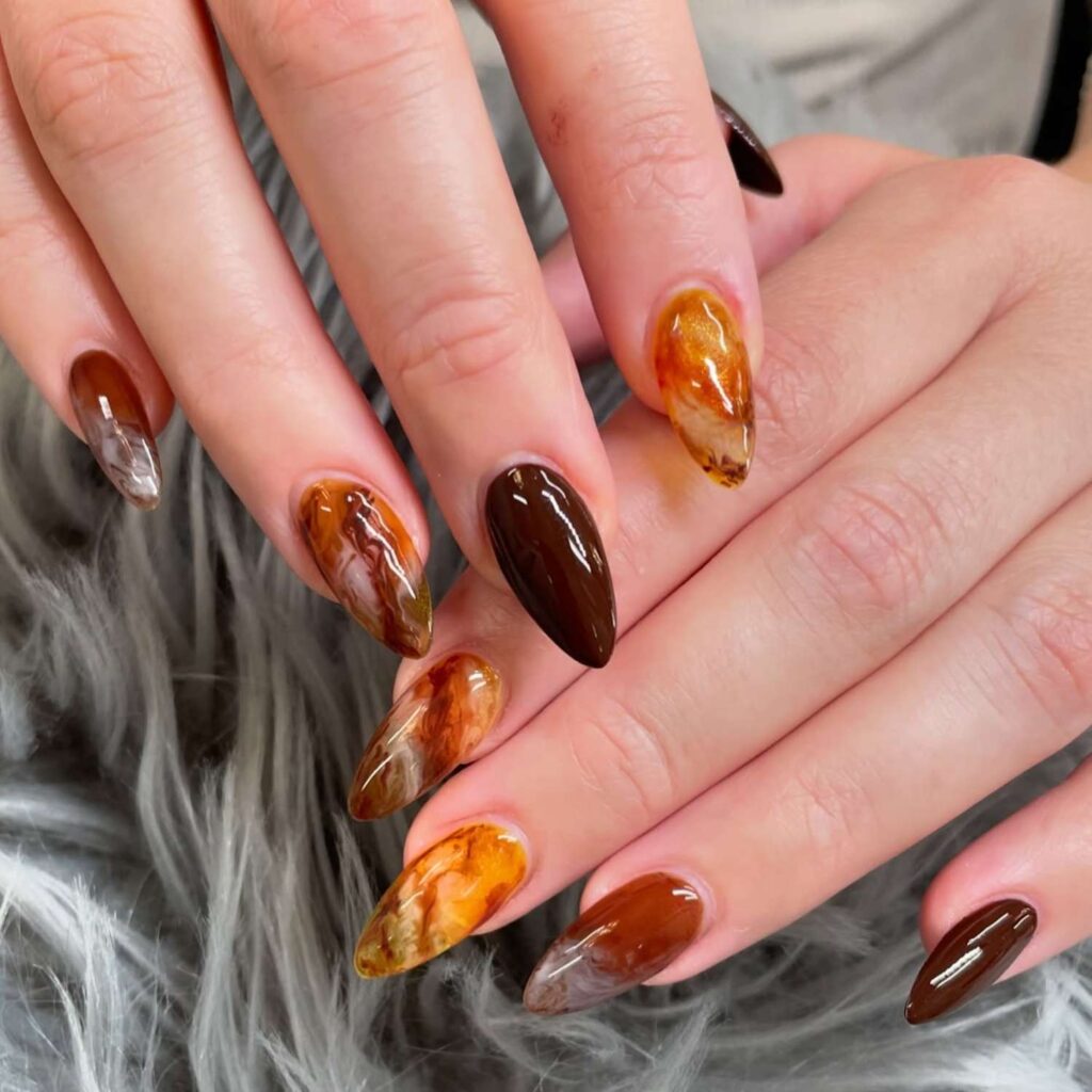 nails with glossy brown and amber marble designs