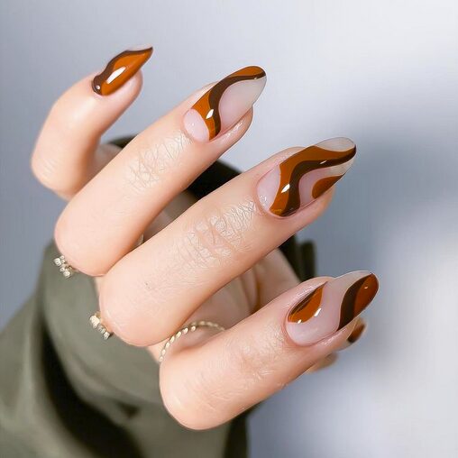 Nude nails with caramel and chocolate brown swirl designs