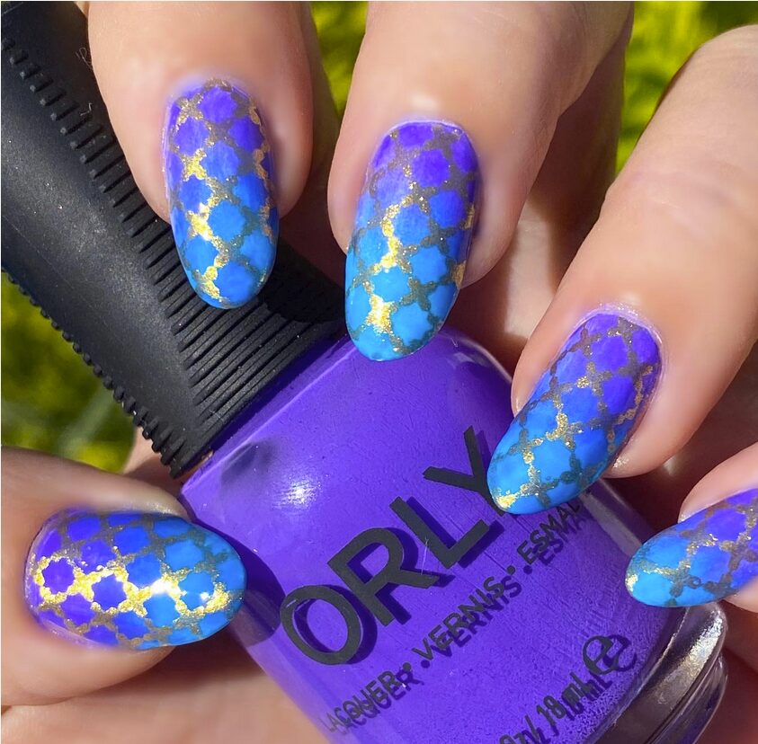 Purple and blue gradient nails with gold geometric detailing