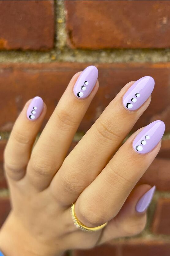 pastel purple almond nails with small silver dot accents