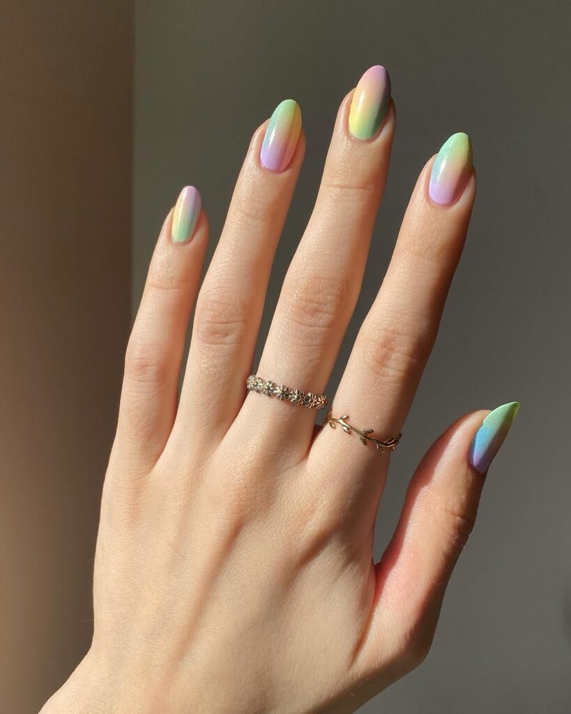 Pastel rainbow manicure with soft pink, lilac, mint, and yellow shades for May