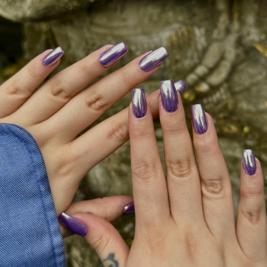 Purple chrome square nails with a reflective metallic finish