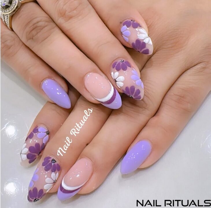 Lilac and purple floral almond nails with glossy and French tip accents