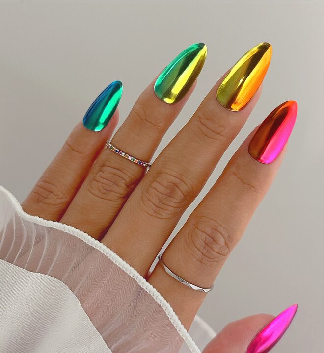 nails featuring a rainbow chrome finish in metallic shades of blue, green, yellow, orange, and pink