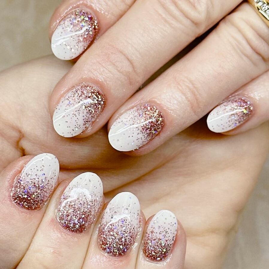 rose gold glitter ombre nails with a creamy white base