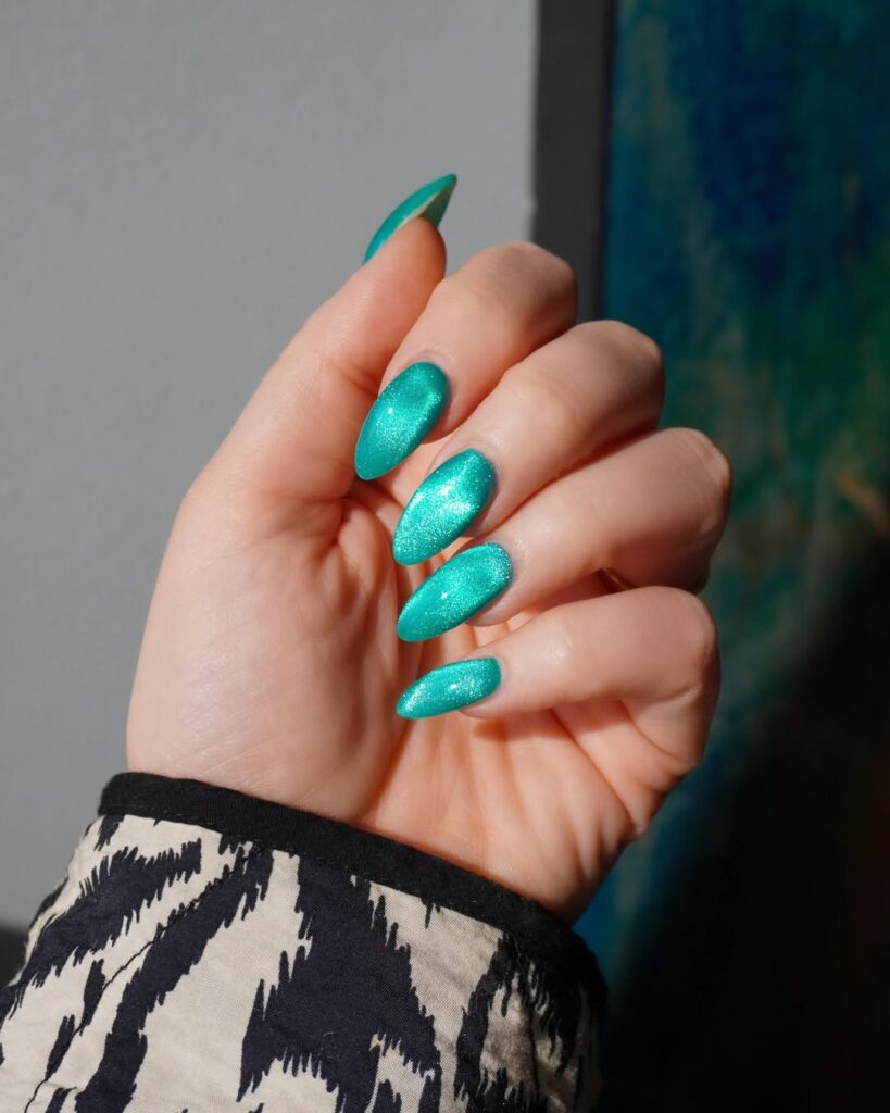 Luminous electric teal velvet almond nails