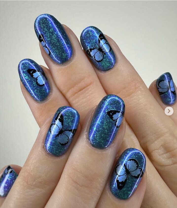 Blue holographic nails with black and white butterfly decals