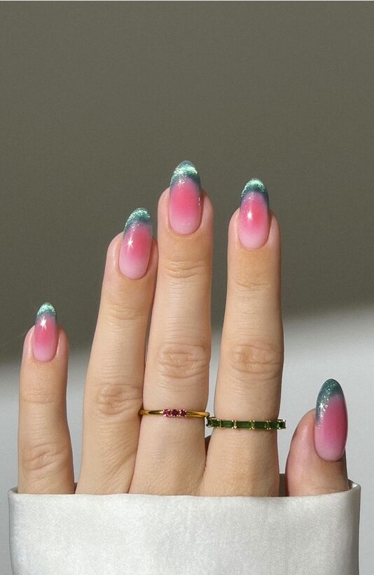 Pink ombré nails with sparkly green tips
