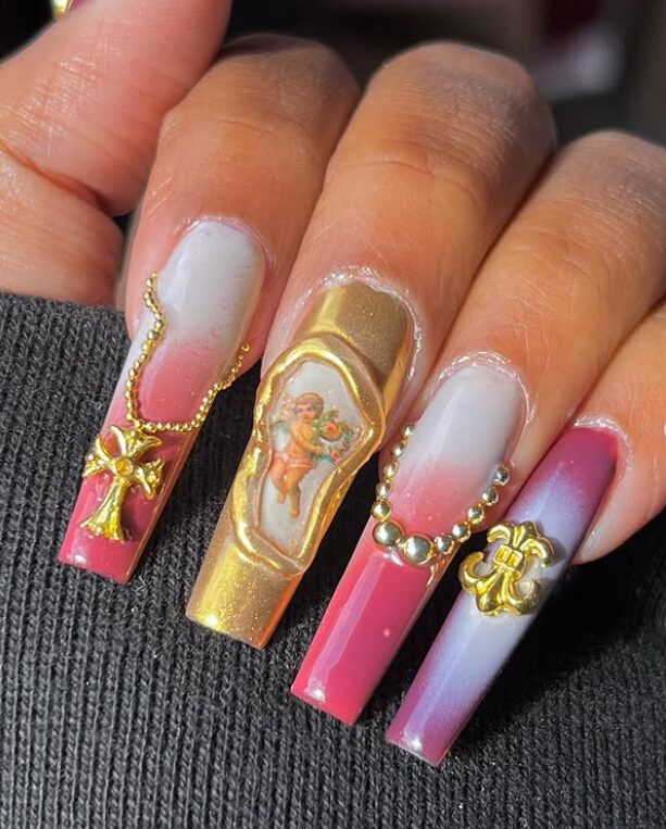 nails featuring a pink and white ombre base with intricate 3D gold embellishments