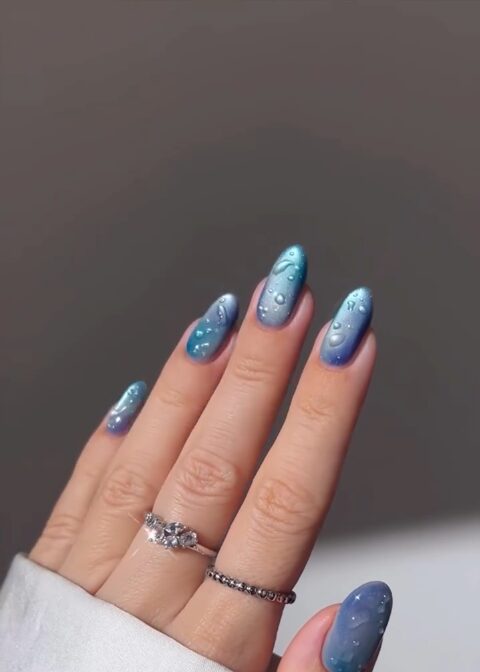 Blue ombré nails with glossy water-droplet accents