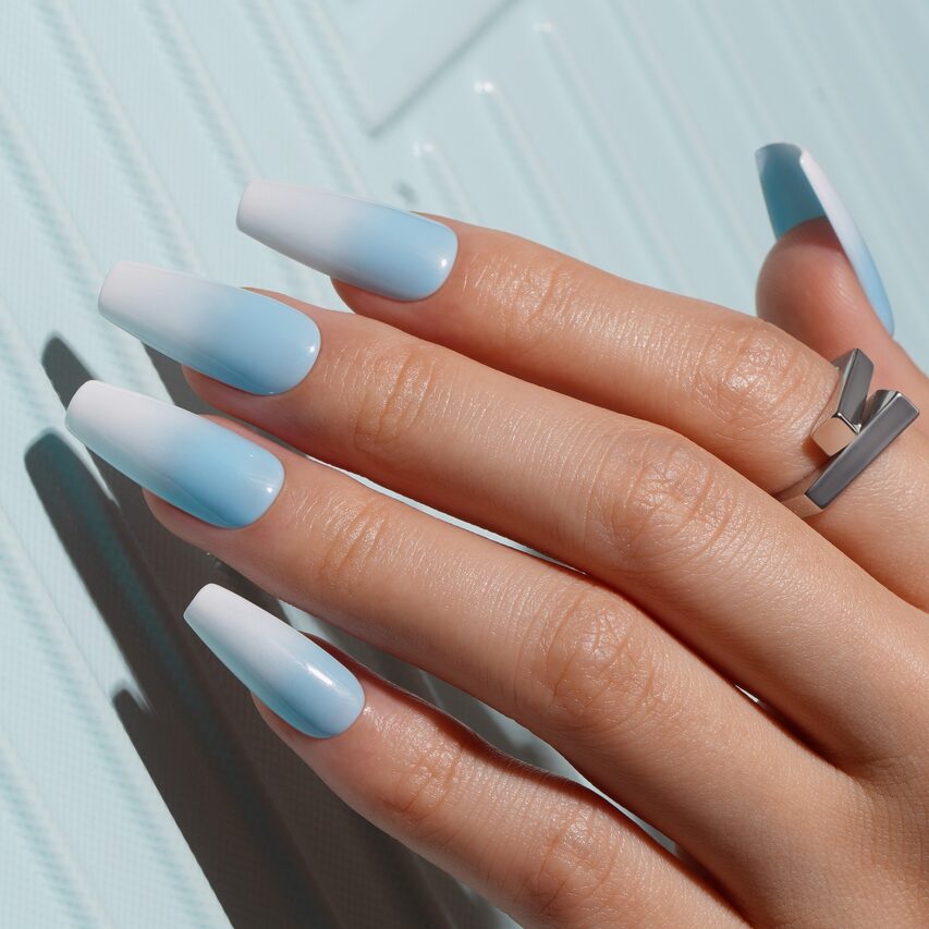 blue-to-white ombré nails with a smooth glossy finish