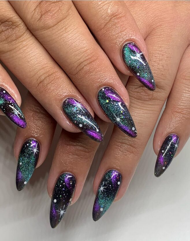 Galaxy-inspired chrome nails in teal, purple, and black