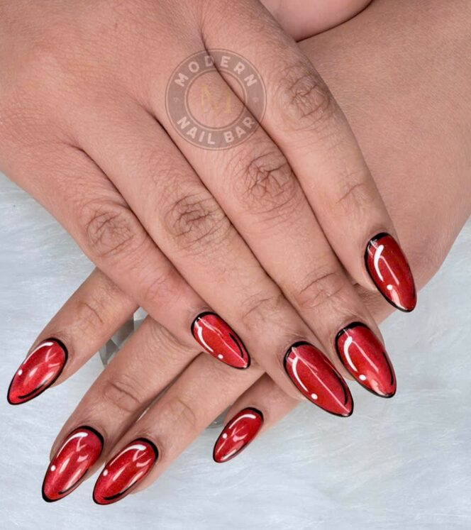 Red chrome almond nails with black outline accents